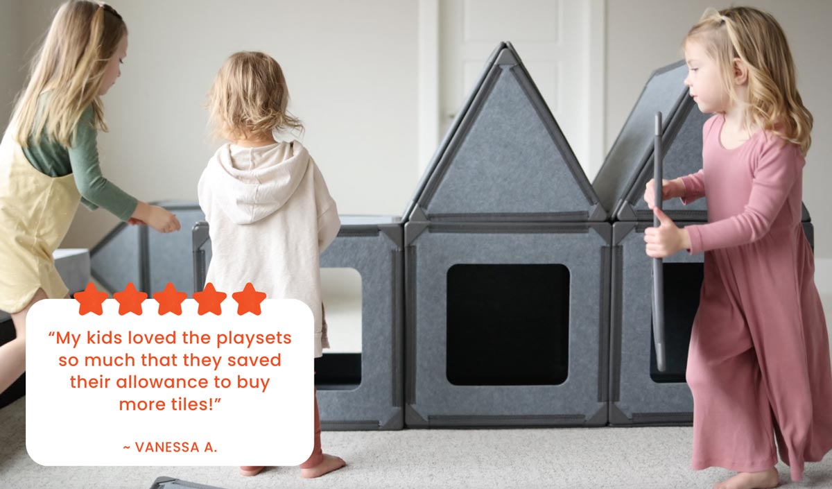 Three children playing with the Superspace Big Set, building a structure with magnetic panels in a cozy indoor setting. The image features a customer review with five stars: "My kids loved the playsets so much that they saved their allowance to buy more tiles!" – Vanessa A. Highlights the playset's appeal and the joy it brings to children.